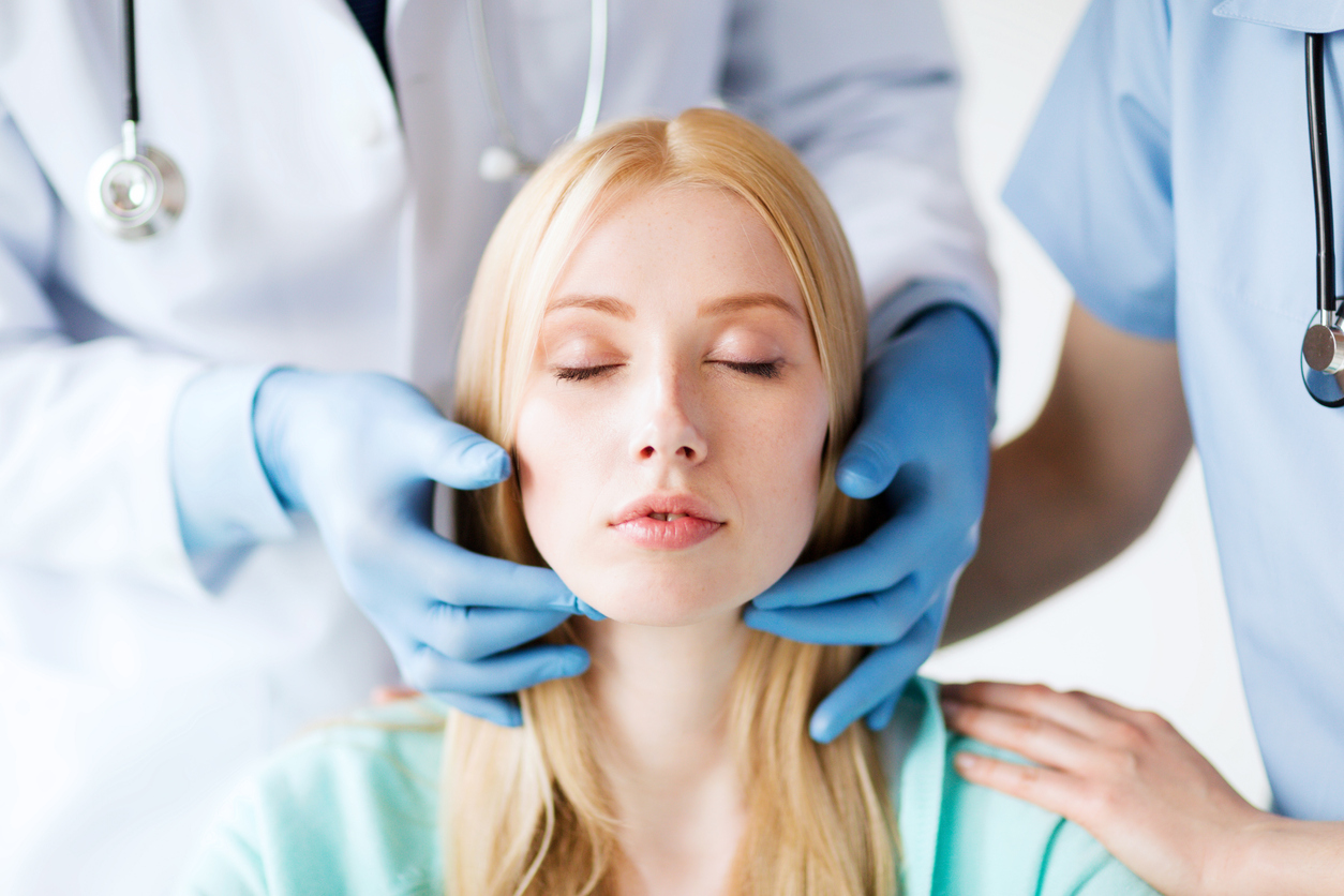 woman getting her neck checked by doctors to prepare for a necklift